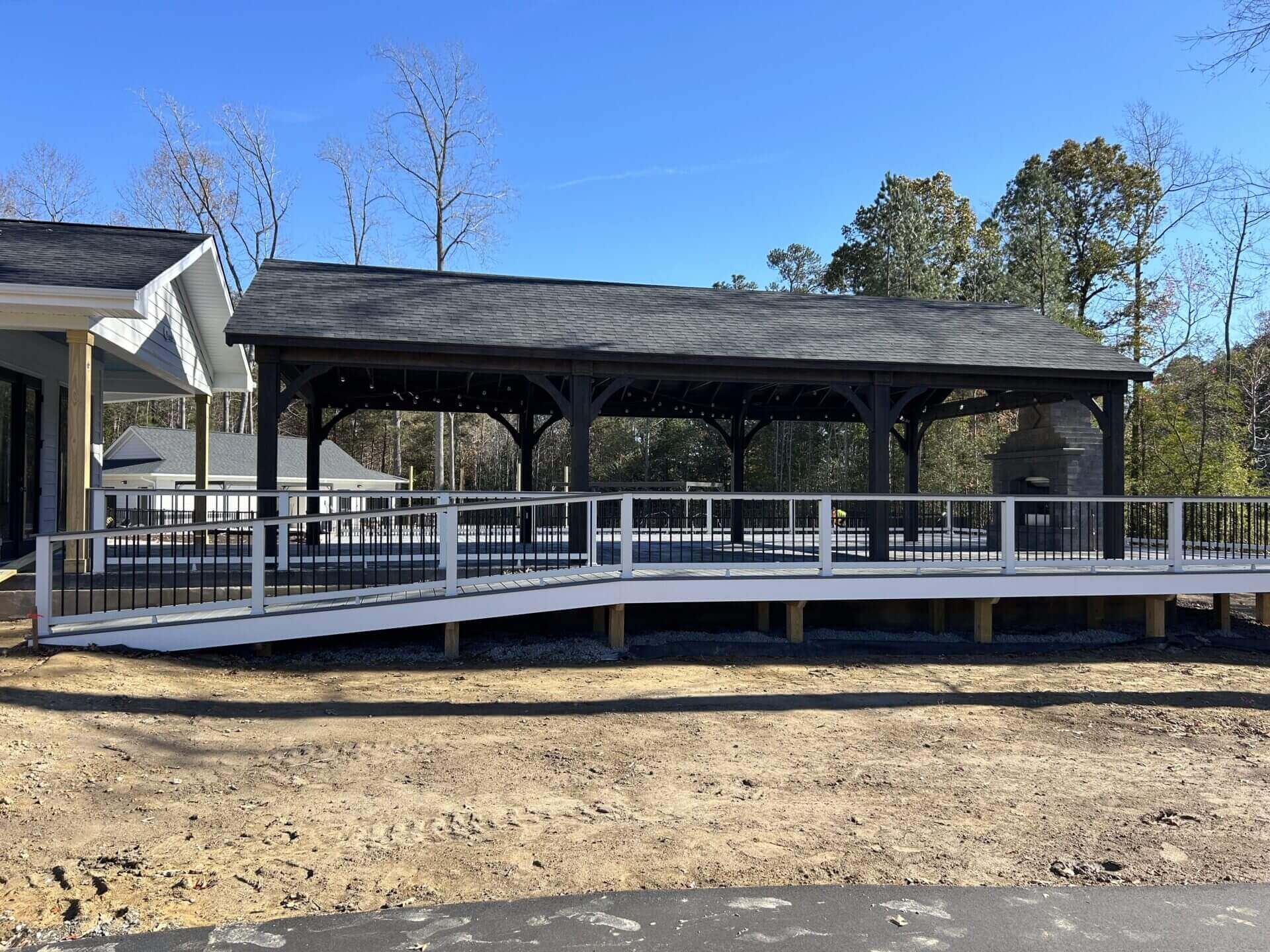 Covered backyard pavilion with ramp and trees in Hampton Roads