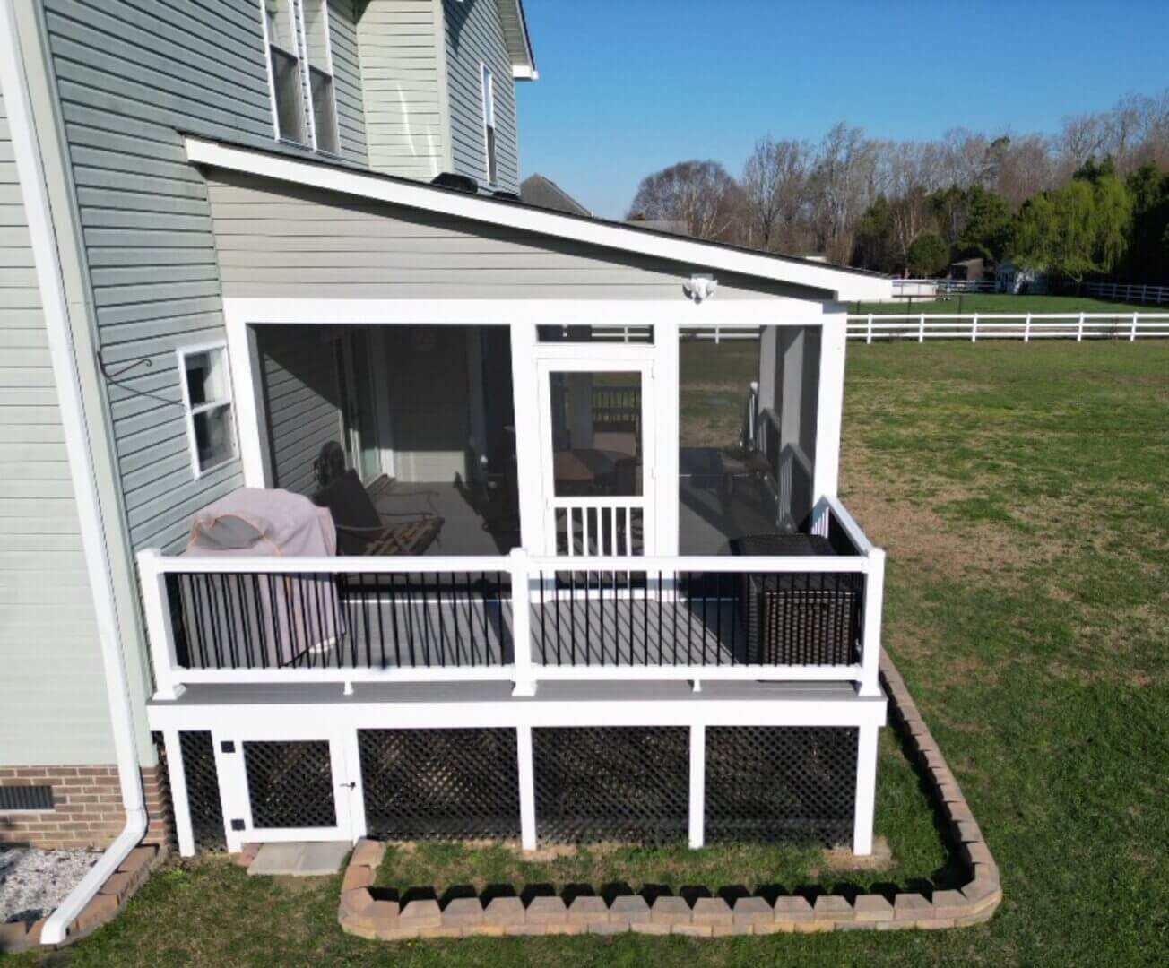 Screened porch attached to a Virginia Beach home with composite decking