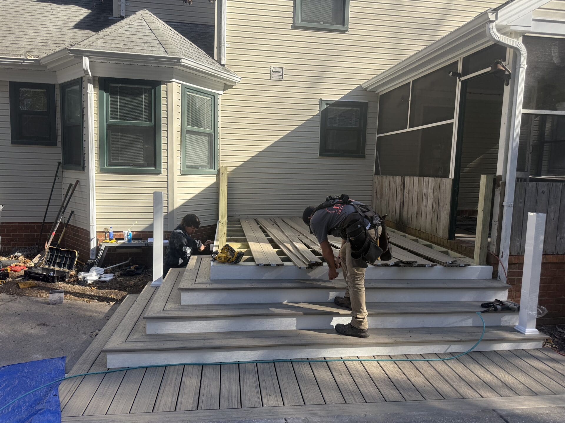 Two-level composite deck with railing in a Chesapeake suburban backyard, built by B&B Decks