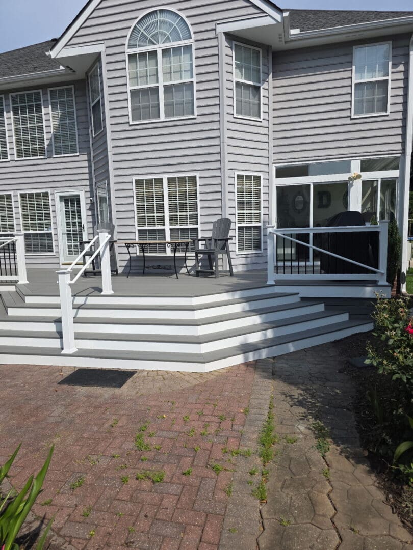 Multi level deck with white railing by B&B Decks