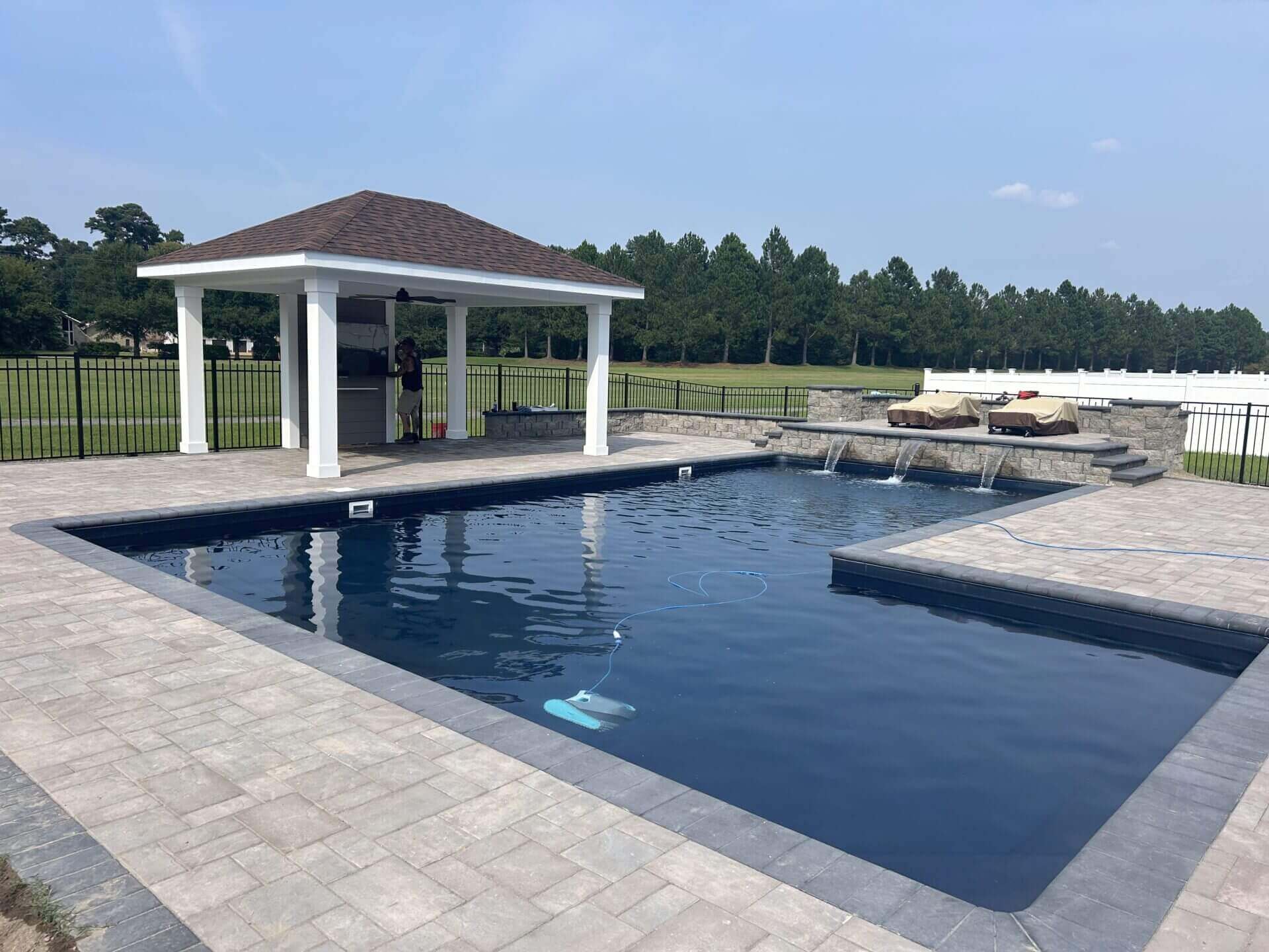 Finished inground pool with surrounding deck and poolside pavilion built by B&B Decks in Hampton Roads