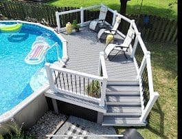 Poolside deck with seating and steps built by B&B Decks in Hampton Roads
