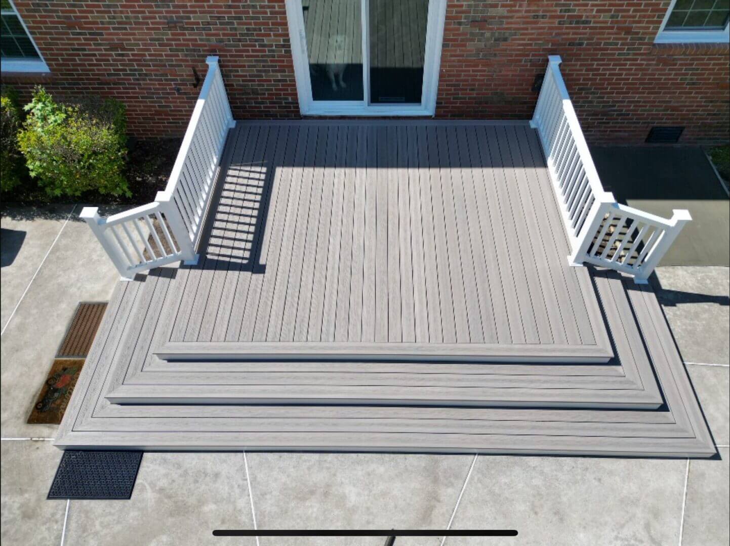 Composite deck with white railing showing what it costs to build a deck in Hampton Roads