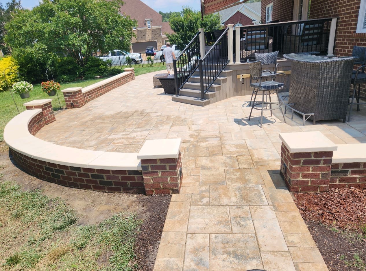 Composite deck with built-in seating and railing in a spacious yard by B&B Decks